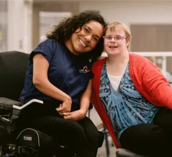 A support professional and client smiling together