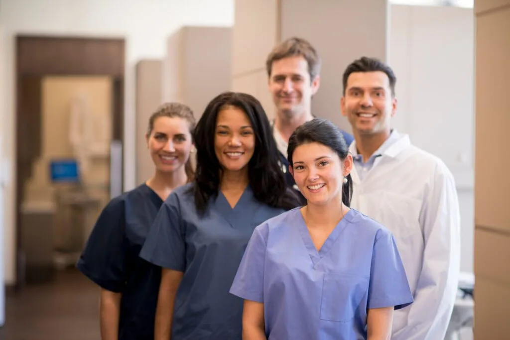 A diverse care team smiling together