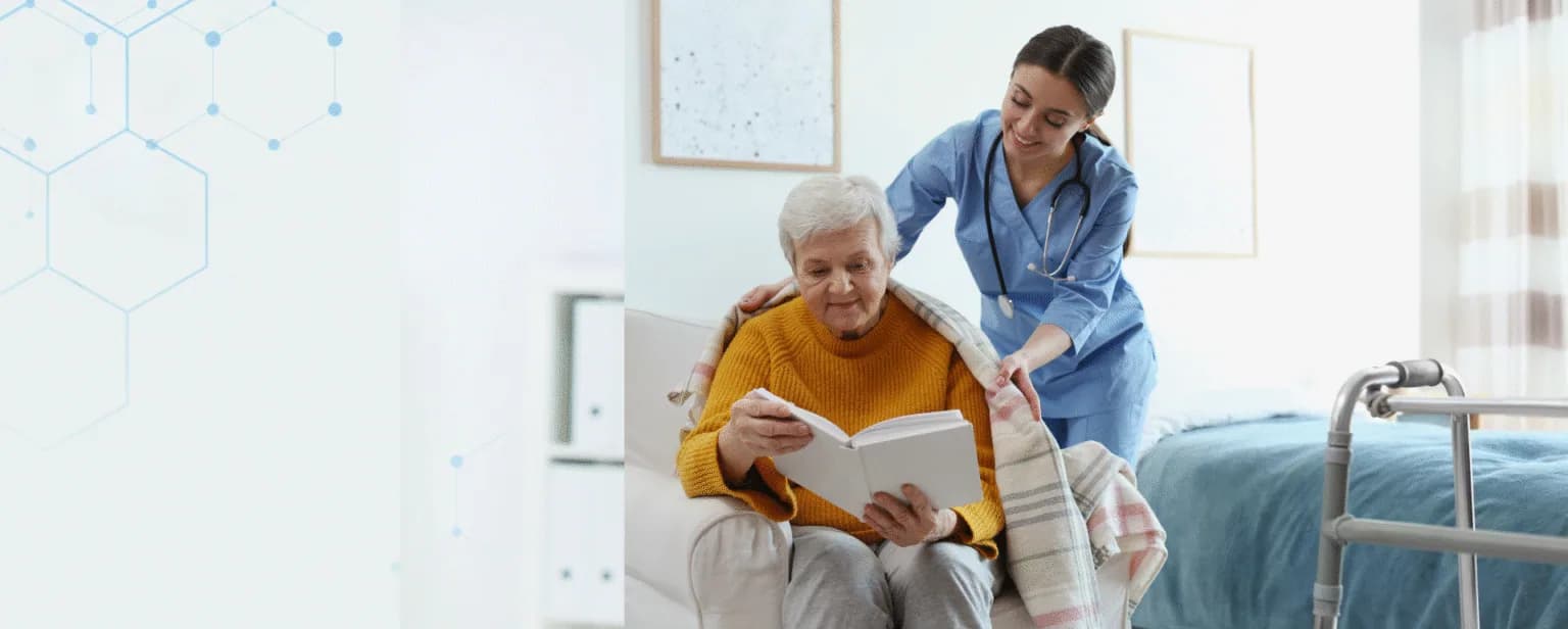 A caregiver supporting an older adult as they read together