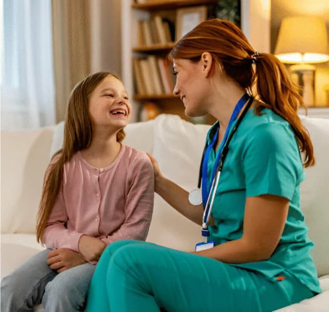 A caregiver talking and laughing with a child at home